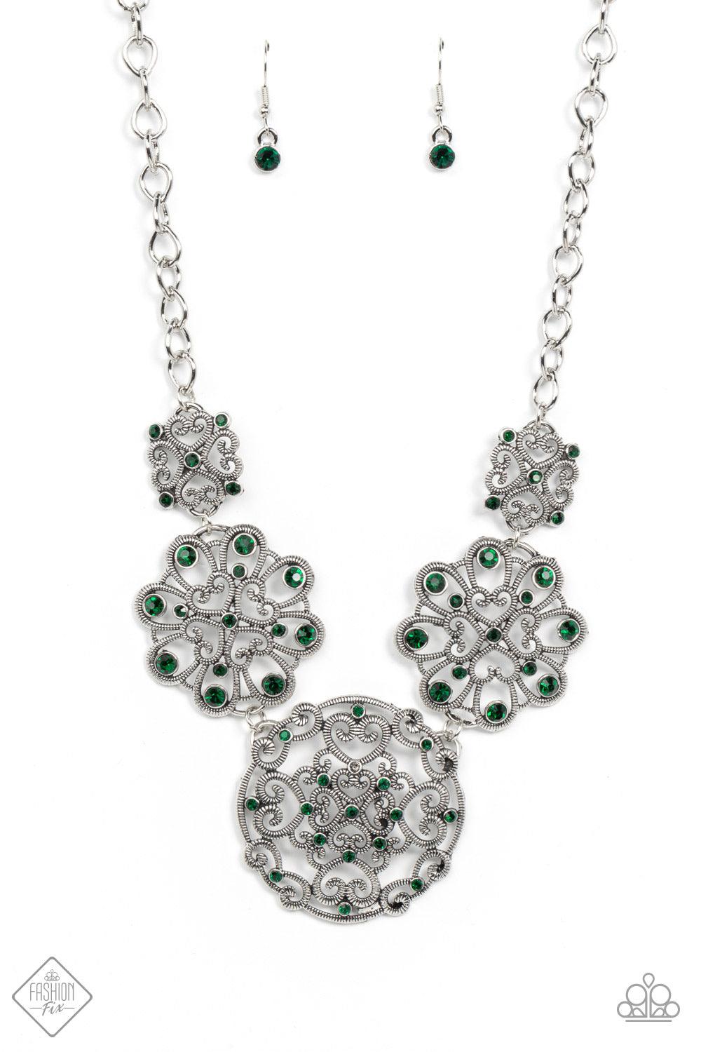 Paparazzi Accessories Royally Romantic - Green Exquisite heart motifs dotted with dainty emerald rhinestones coalesce into airy medallions that link to a modest silver chain. The varying sizes and permeating patterns of the medallions create a romanticall
