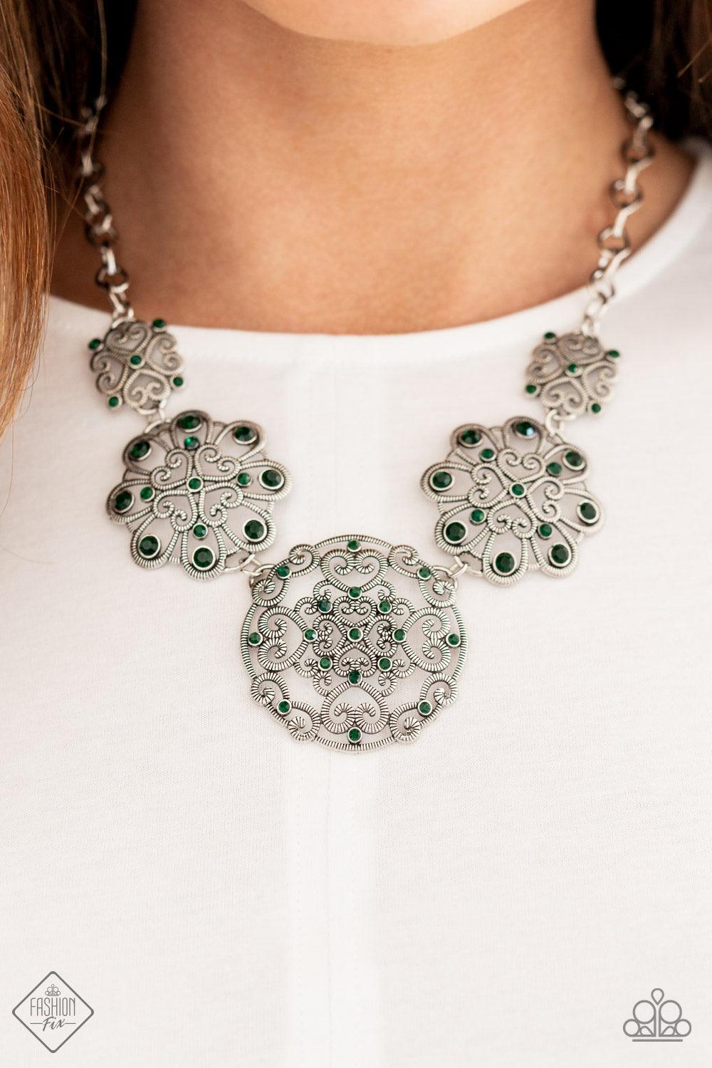 Paparazzi Accessories Royally Romantic - Green Exquisite heart motifs dotted with dainty emerald rhinestones coalesce into airy medallions that link to a modest silver chain. The varying sizes and permeating patterns of the medallions create a romanticall