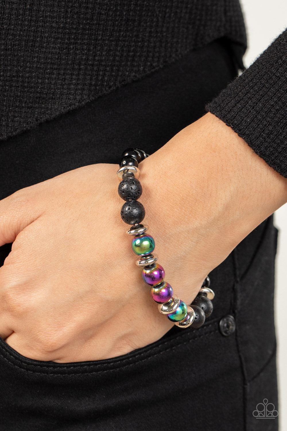 Paparazzi Accessories Mega Metamorphic - Multi Infused with a section of polished black beads, a stellar assortment of oil spill beads, silver accents, and black lava rock beads are threaded along stretchy bands around the wrist for an urban flair. Sold a