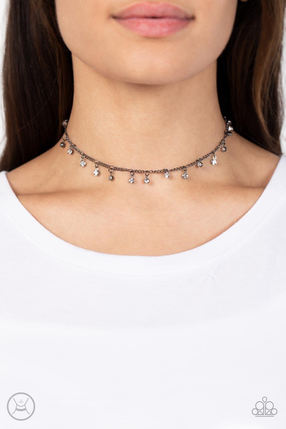Paparazzi Accessories Bringing SPARKLE Back - Black Encased in gritty gunmetal fittings, glassy white rhinestones dance from the bottom of a dainty gunmetal chain for a dash of spell-binding radiance around the neck. Sold as one individual choker necklace