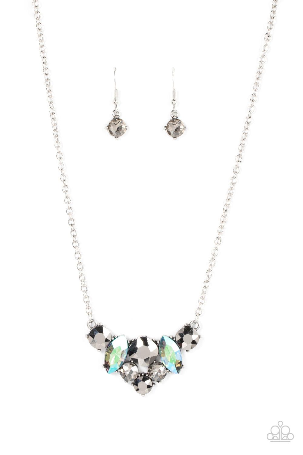 Paparazzi Accessories Lavishly Loaded - Silver A smoldering collection of smoky, iridescent, and hematite gems of various cuts coalesces into a lavish frame at the bottom of a classic silver chain, resulting in a glamorous finish below the collar. Sold as
