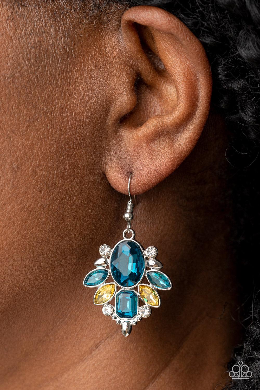 Paparazzi Accessories Glitzy Go-Getter - Multi A brilliant blue gem makes a sparkling centerpiece amidst a glitzy fringe of marquise, round, and emerald cut blue, yellow, and white rhinestones resulting in a timeless lure. Earring attaches to a standard f
