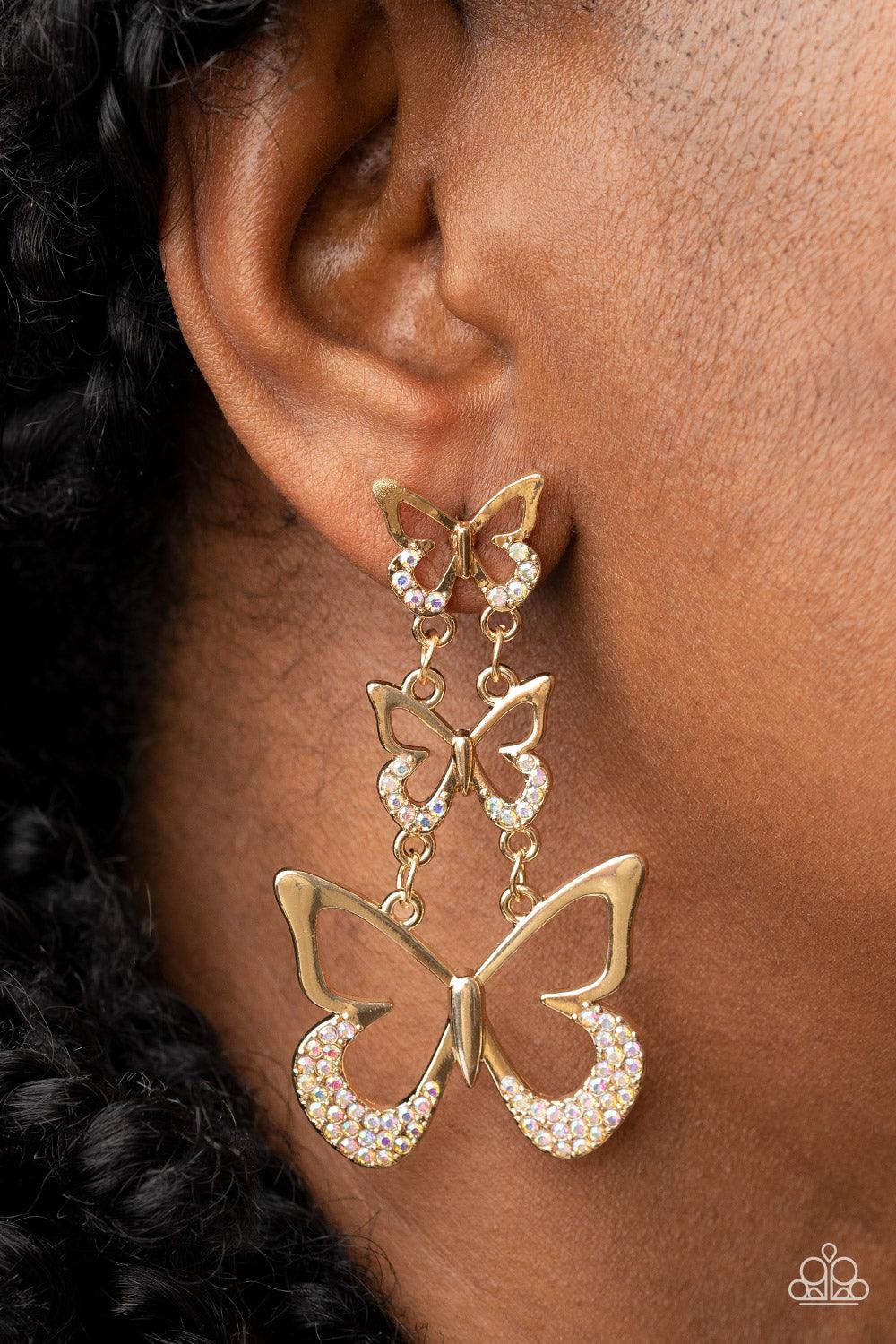 Paparazzi Accessories Flamboyant Flutter - Multi An airy trio of gold butterflies gradually increase in size as they link into a whimsical lure. The bottom of each butterfly has been dipped in iridescent rhinestones, adding a glitzy finish to the flutteri