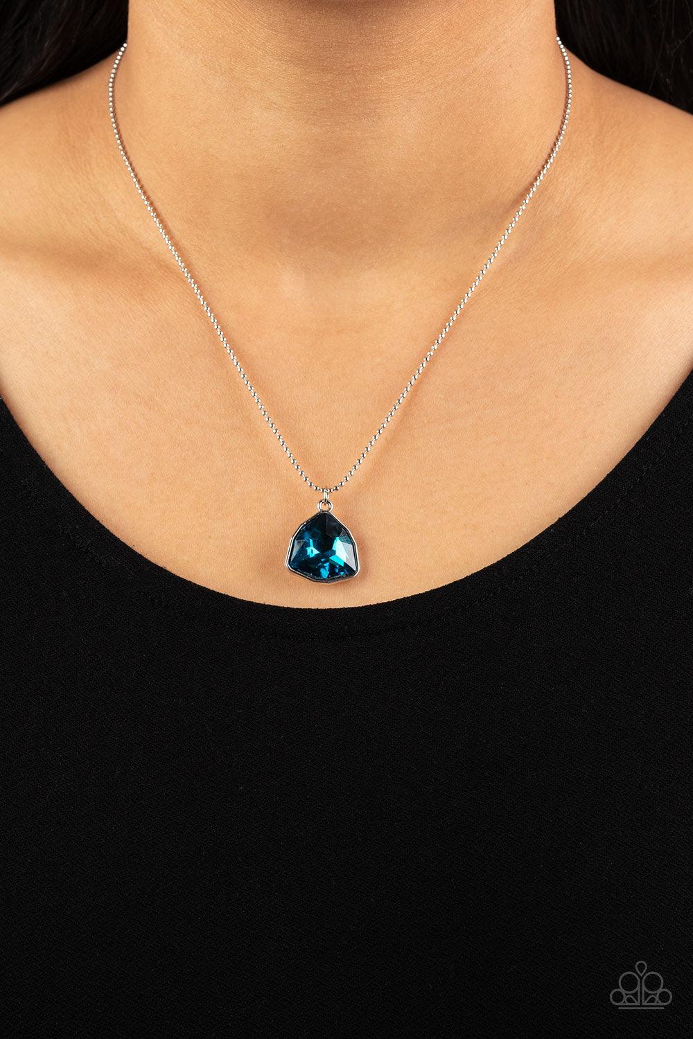 Paparazzi Accessories Galactic Duchess - Blue A faceted asymmetrical blue gem is encased in a sleek silver frame at the bottom of a silver popcorn chain, creating a stellar pendant below the collar. Features an adjustable clasp closure. Sold as one indivi