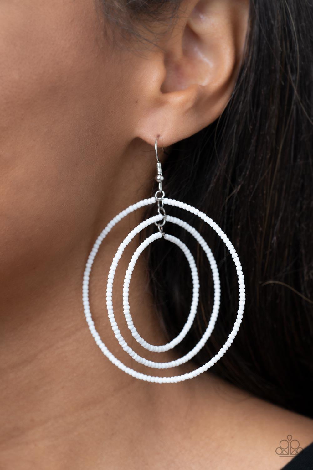 Paparazzi Accessories Colorfully Circulating - White Three oversized rings of dainty white seed beads ripple into colorfully layered hoops, resulting in a dizzying display. Earring attaches to a standard fishhook fitting. Sold as one pair of earrings. Ear