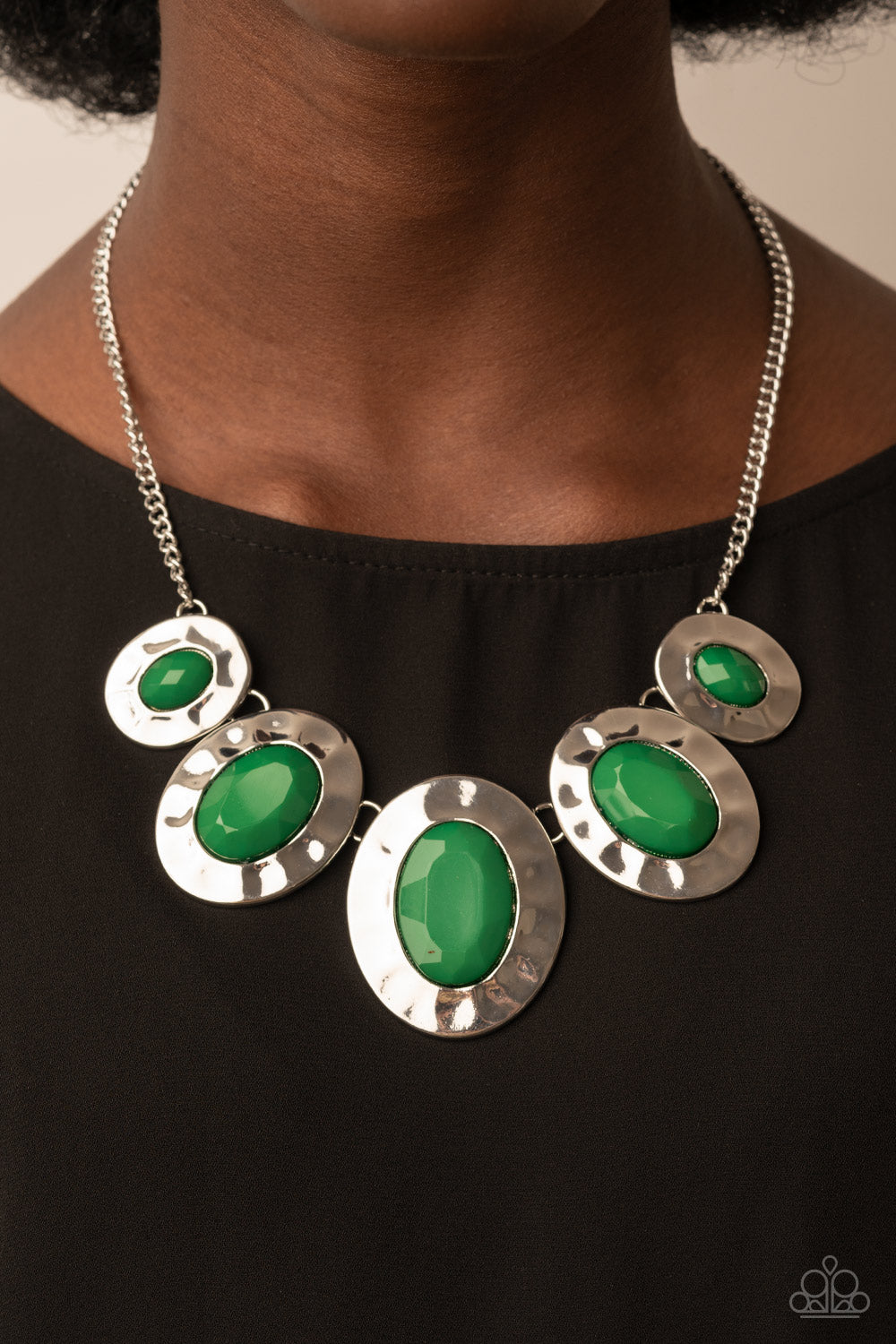 Paparazzi Accessories Rivera Rendezvous - Green Gradually increasing in size, hammered silver oval frames are dotted with opalescent Leprechaun beads as they delicately link below the collar for a refreshing pop of color. Features an adjustable clasp clos