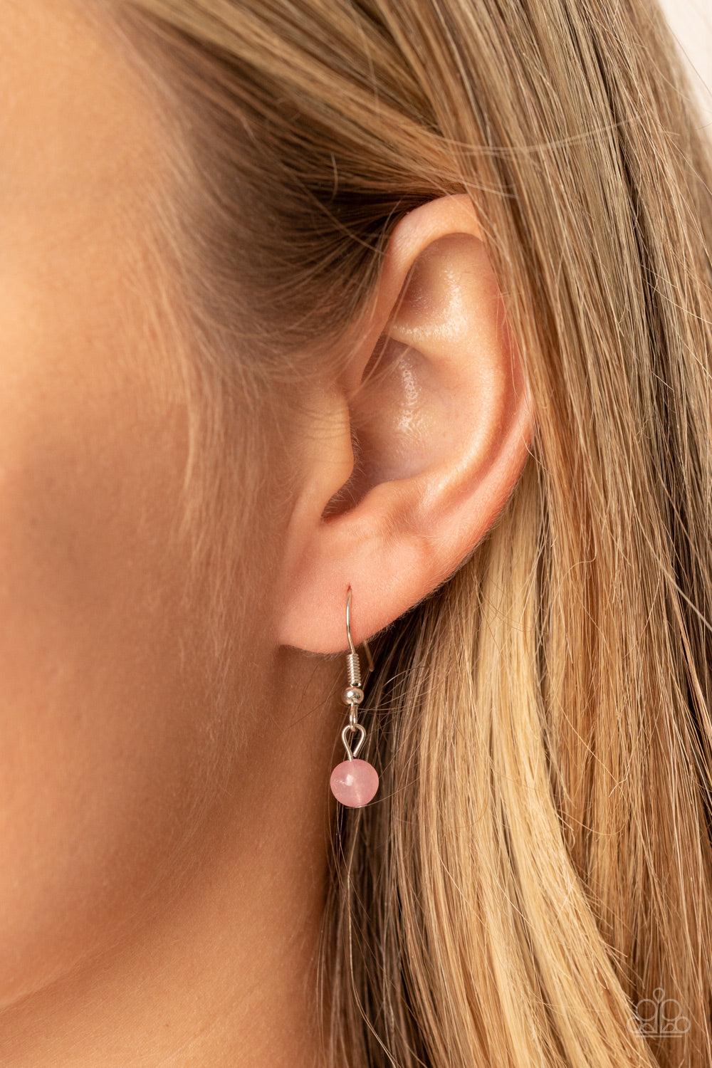 Paparazzi Accessories Magnificent Manifestation - Pink Bordered in a ring of flat silver studs, a mystical pink bead adorns the top of a textured silver half moon pendant that glides along a rounded silver snake chain for an ethereal fashion. Features an