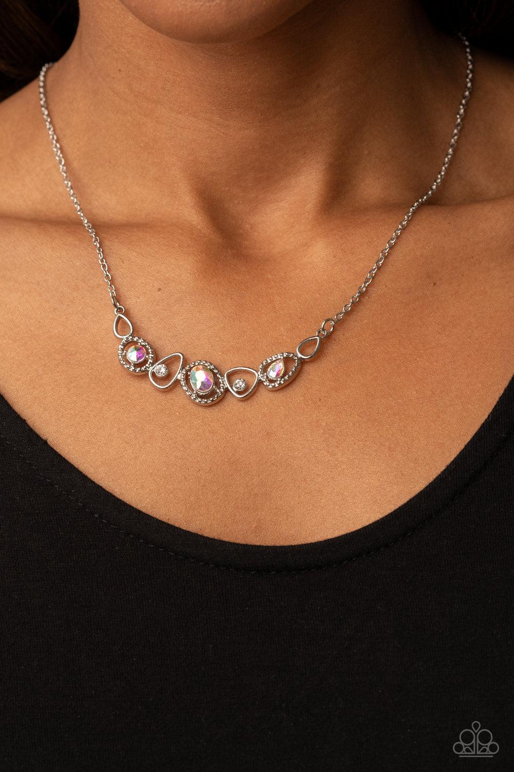 Paparazzi Accessories Celestial Cadence - Multi An incandescent assortment of shiny silver frames, dainty white rhinestones, and oversized iridescent gems delicately coalesce into a statement-making sparkle below the collar. Features an adjustable clasp c