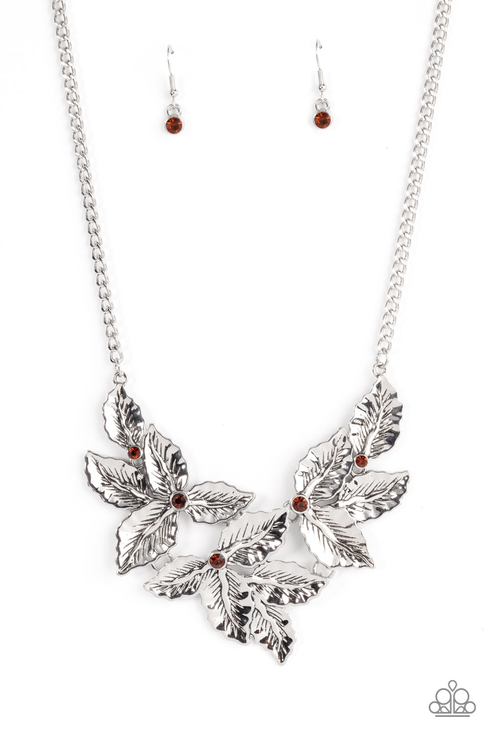 Paparazzi Accessories Holly Heiress - Brown A textured collection of silver holly-like leaves are dotted with dainty topaz rhinestones as they bloom below the collar, invoking a festive spirit. Features an adjustable clasp closure. Sold as one individual