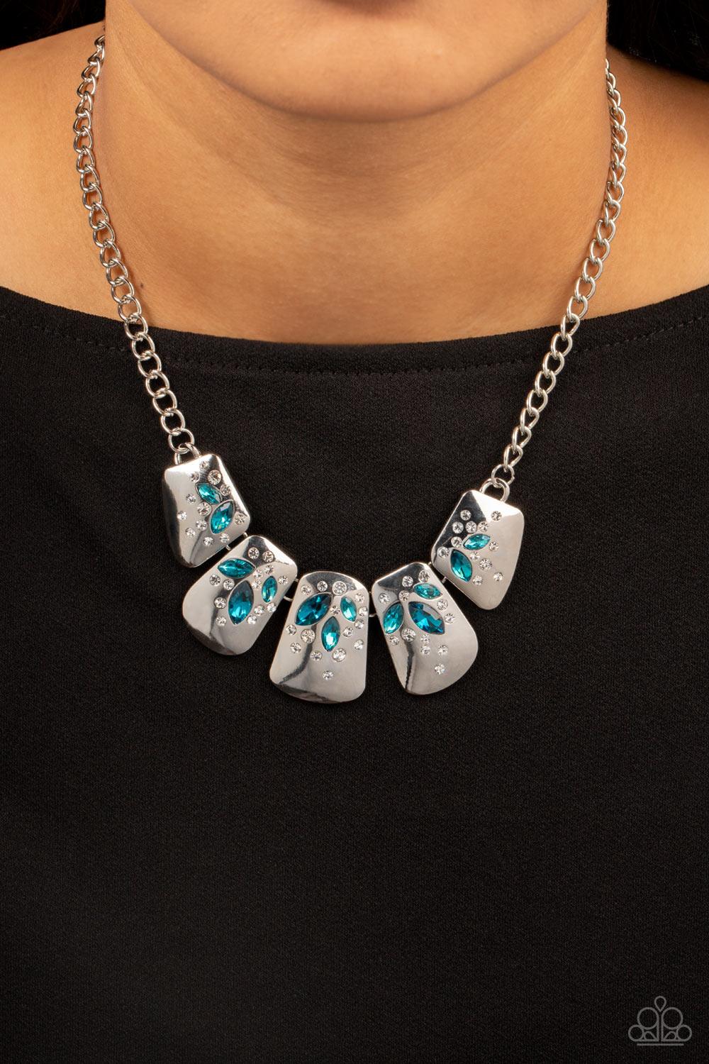 Paparazzi Accessories Jubilee Jingle - Blue Dotted with glassy white rhinestones, curved silver plates are encrusted in glittery blue marquise cut rhinestones below the collar, resulting in a jubilant centerpiece. Features an adjustable clasp closure. Sol