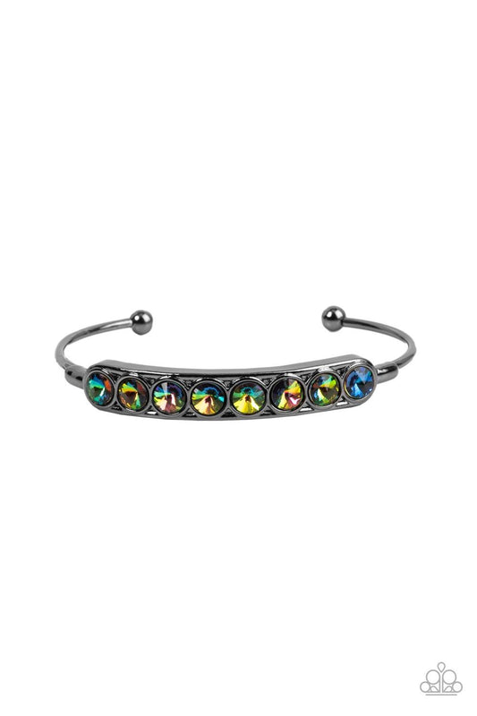Paparazzi Accessories Vertigo Views - Multi A frame of oversized oil spill rhinestones is set atop a dainty gunmetal cuff featuring gunmetal beaded fittings, resulting in a stellar and stackable centerpiece. Sold as one individual bracelet. Jewelry
