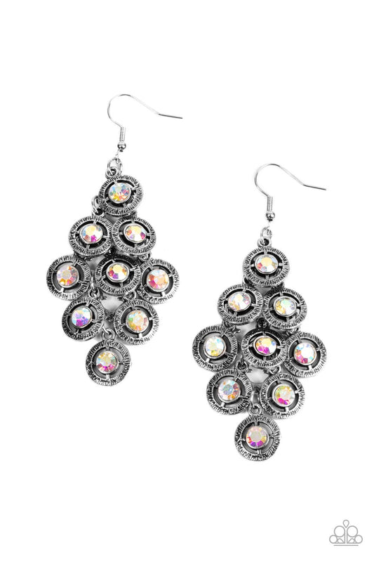 Paparazzi Accessories Constellation Cruise - Multi Dotted with iridescent rhinestone centers, tiers of textured silver frames cascade from a metallic backdrop for a stellar tasseled look. Earring attaches to a standard fishhook fitting. Sold as one pair o