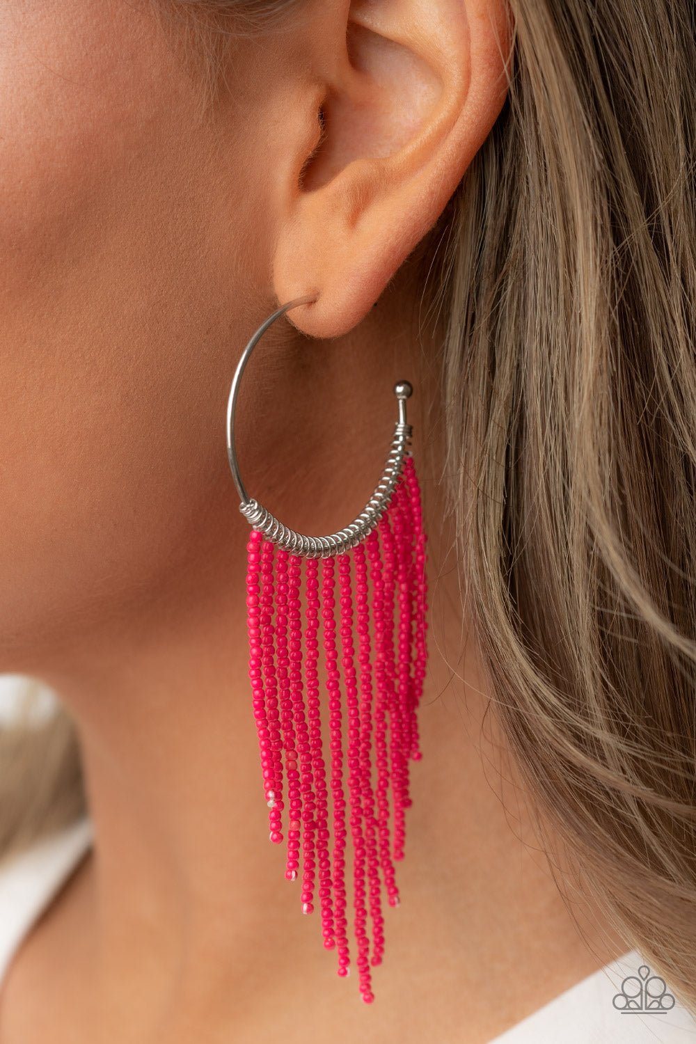 Paparazzi Accessories Saguaro Breeze - Pink Strands of dainty pink seed beads stream out from the bottom of a classic silver hoop, resulting in a flirtatiously tasseled look. Earring attaches to a standard post fitting. Hoop measures approximately 1 1/2"