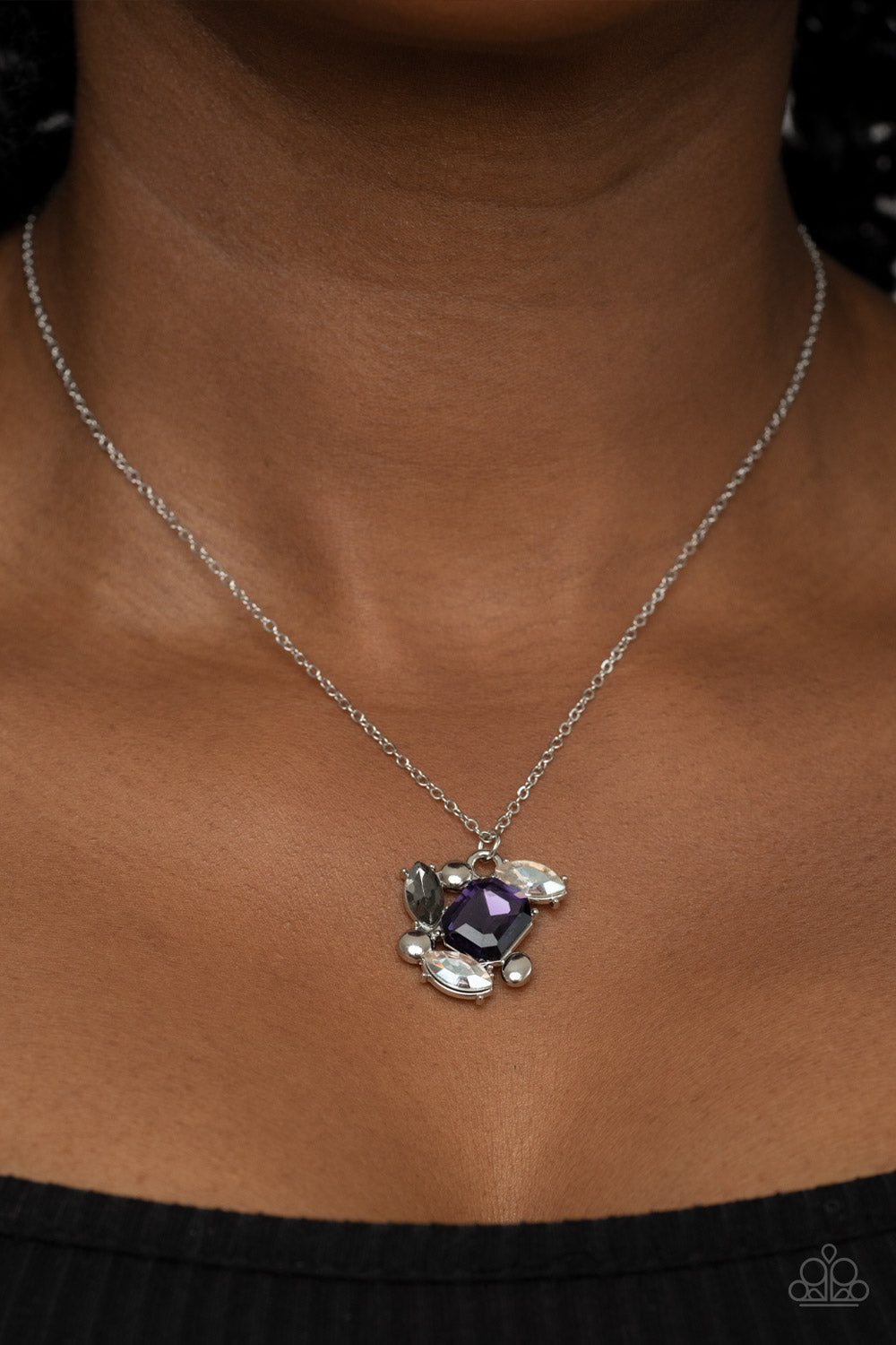 Paparazzi Accessories Prismatic Projection - Purple A glitzy collection of dainty silver studs, an emerald cut purple gem, and smoky and white marquise cut rhinestones delicately coalesce into a clustered pendant, resulting in a timeless sparkle below the