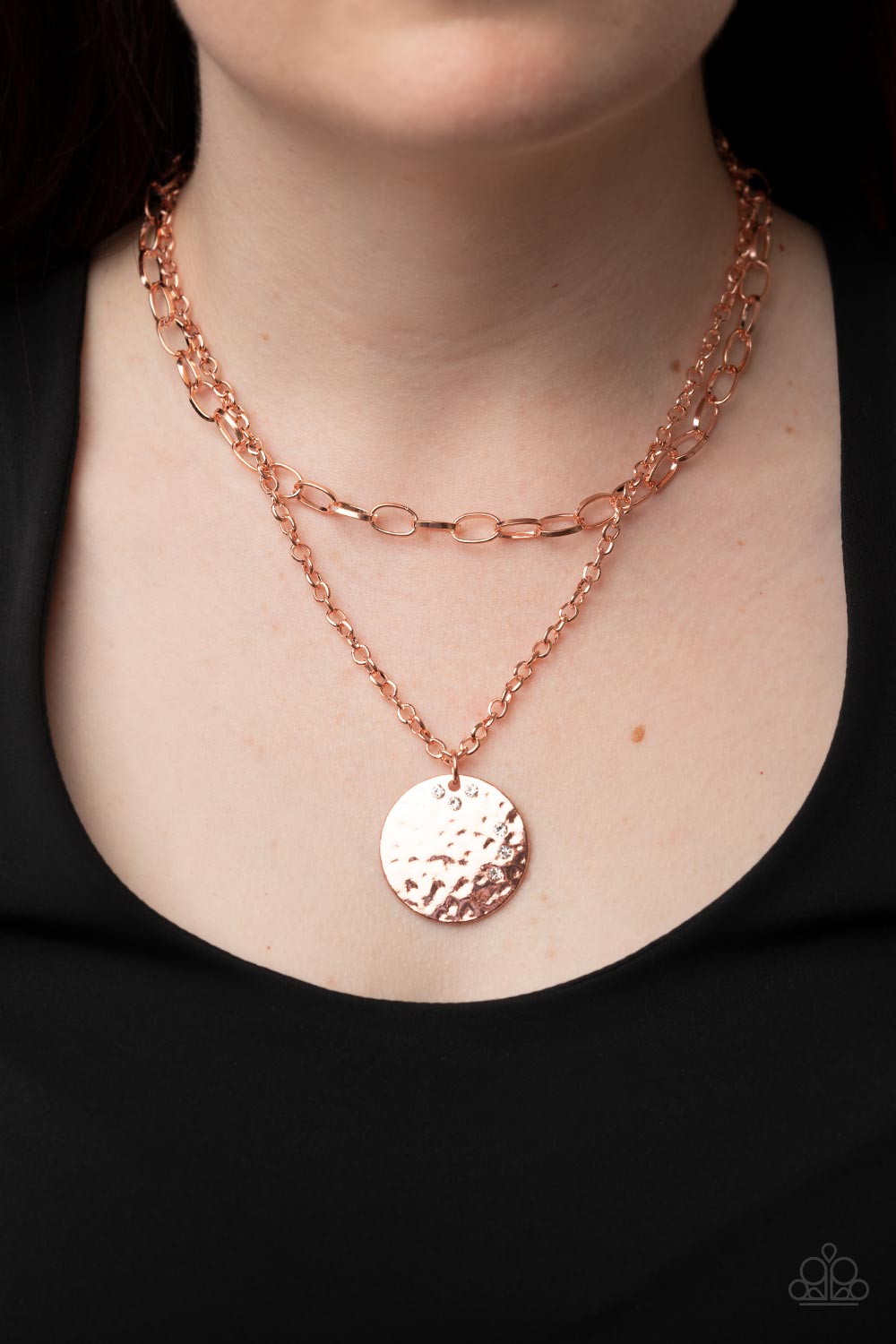 Paparazzi Accessories Highlight of My Life - Copper Sporadically dotted in glittery white rhinestones, an oversized hammered shiny copper disc is suspended from the lowermost of two mismatched shiny copper chains below the collar for a retro look. Feature
