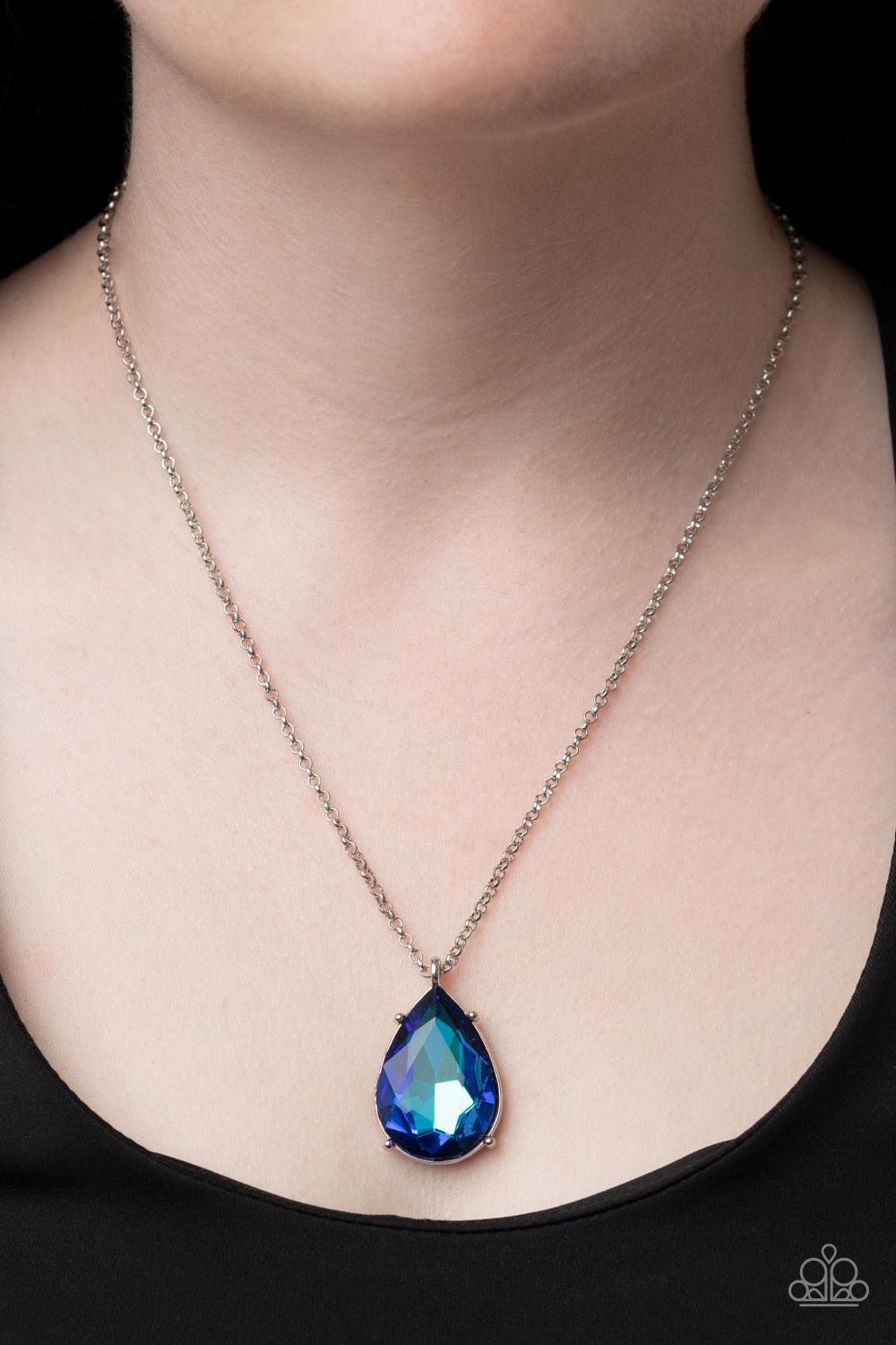 Paparazzi Accessories Illustrious Icon - Blue Featuring a pronged fitting, a dramatically oversized iridescent blue teardrop gem sparkles at the bottom of a silver chain for an iconic fashion. Features an adjustable clasp closure. Sold as one individual n
