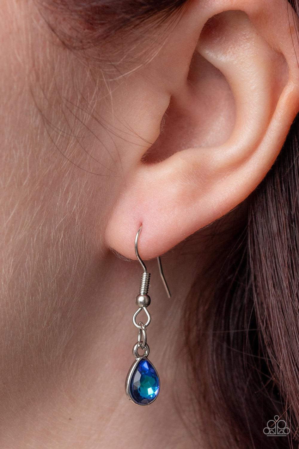 Paparazzi Accessories Illustrious Icon - Blue Featuring a pronged fitting, a dramatically oversized iridescent blue teardrop gem sparkles at the bottom of a silver chain for an iconic fashion. Features an adjustable clasp closure. Sold as one individual n