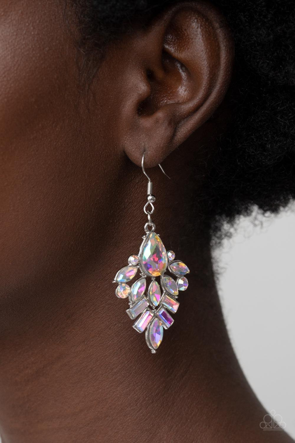 Paparazzi Accessories Stellar-escent Elegance - Multi A stunning stack of round, emerald, teardrop, and marquise cut iridescent rhinestones lavishly fans out into a stellar lure. Earring attaches to a standard fishhook fitting. Sold as one pair of earring
