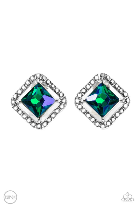 Paparazzi Accessories Cosmic Catwalk - Green *Clip-On Featuring an iridescent UV finish, an emerald cut green gem seemingly floats in the center of a hematite rhinestone encrusted frame for a stellar statement. Earring attaches to a standard clip-on fitti