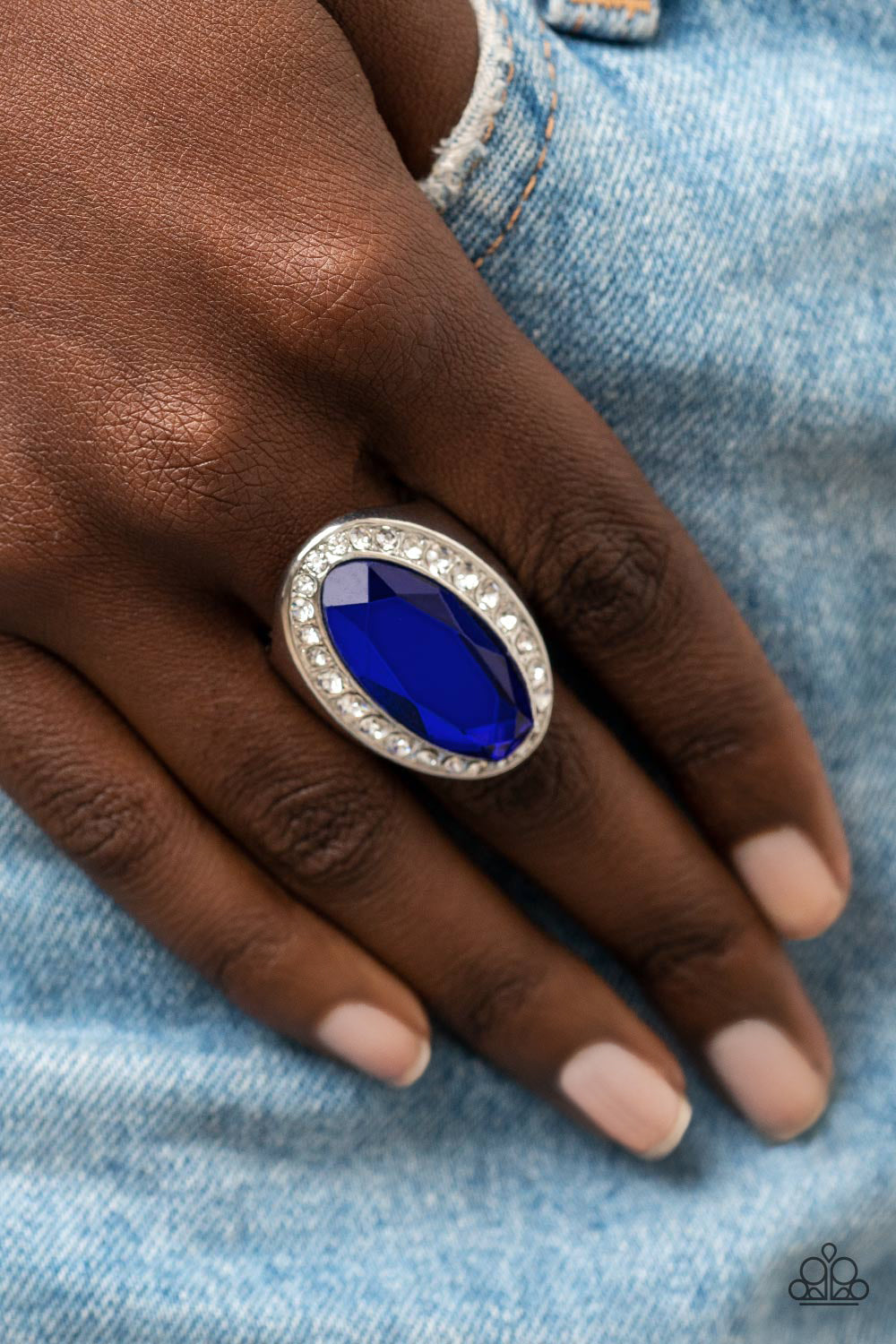 Paparazzi Accessories Believe in Bling - Blue Bordered by a glitzy ring of white rhinestones, an oblong blue gem embellishes the center of a dramatically oversized silver frame for a blinding finish. Features a stretchy band for a flexible fit. Sold as on