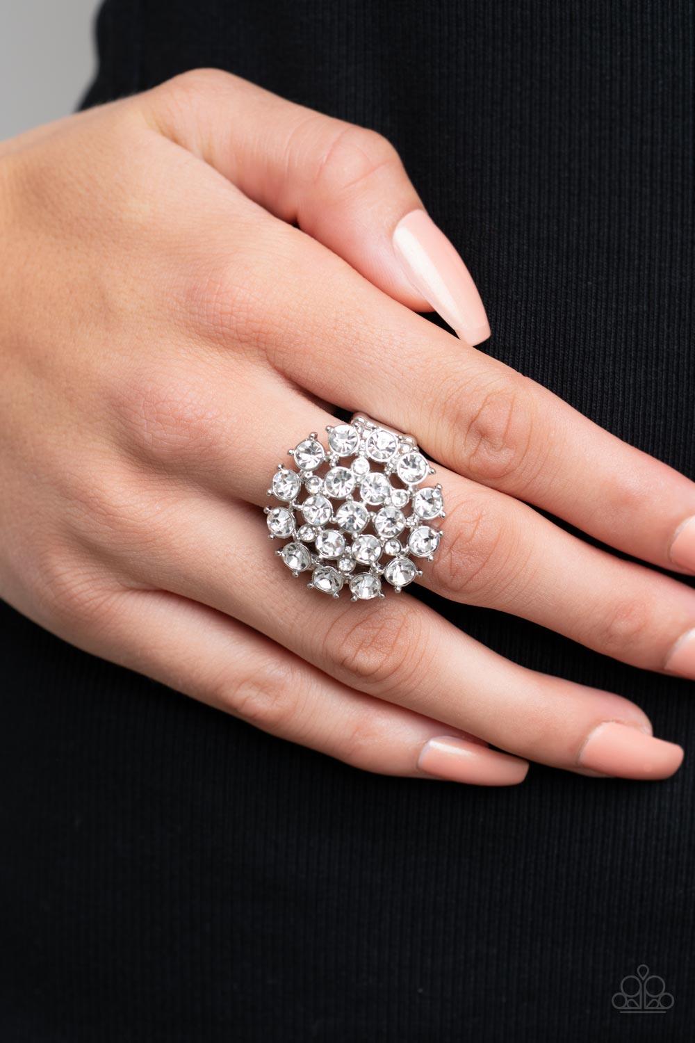 Paparazzi Accessories SELFIE-Confidence - White Featuring pronged silver fittings, an explosion of glassy white rhinestones sparkles atop the finger for a statement-making fashion. Features a stretchy band for a flexible fit. Sold as one individual ring.