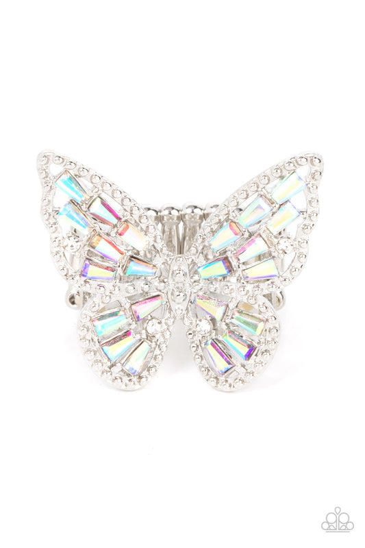 Paparazzi Accessories Bright-Eyed Butterfly - Multi A glitzy collection of emerald cut iridescent rhinestones are sprinkled across the studded wings of a shiny silver butterfly, resulting in a whimsical centerpiece atop the finger. Features a stretchy ban