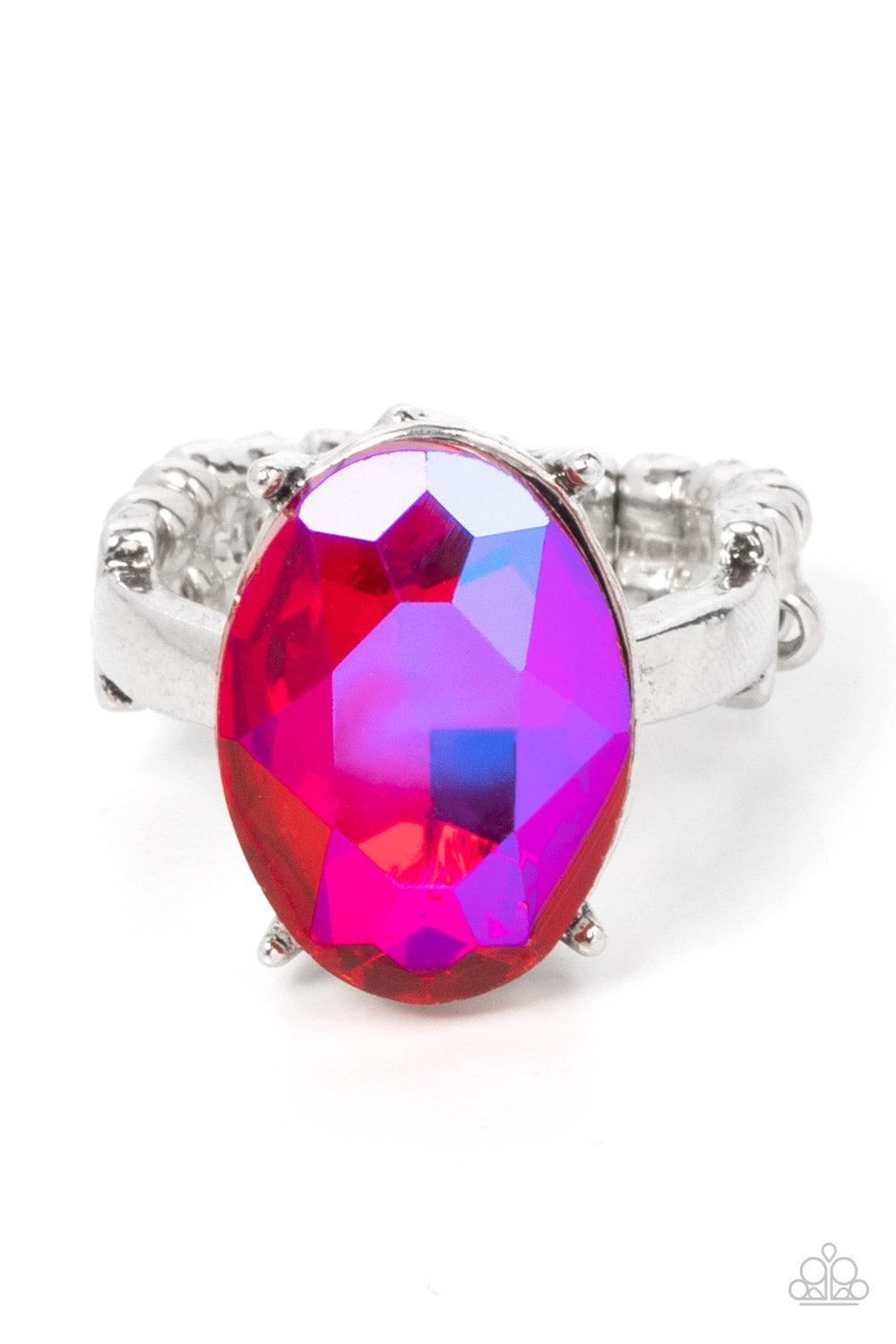 Paparazzi Accessories Updated Dazzle - Pink A stunning faceted iridescent pink gem, set in edgy pronged fittings, creates a glamorous show-stopping centerpiece atop sleek silver bands. Features a dainty stretchy band for a flexible fit. Sold as one indivi