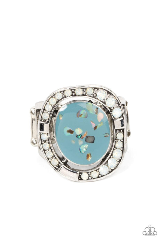 Paparazzi Accessories Beach Bijou - Blue Flecked in shell-like accents, an asymmetrical Spring Lake frame seemingly floats inside an imperfectly round silver frame dotted in sections of opal white rhinestones and shiny silver accents, invoking a beach ins