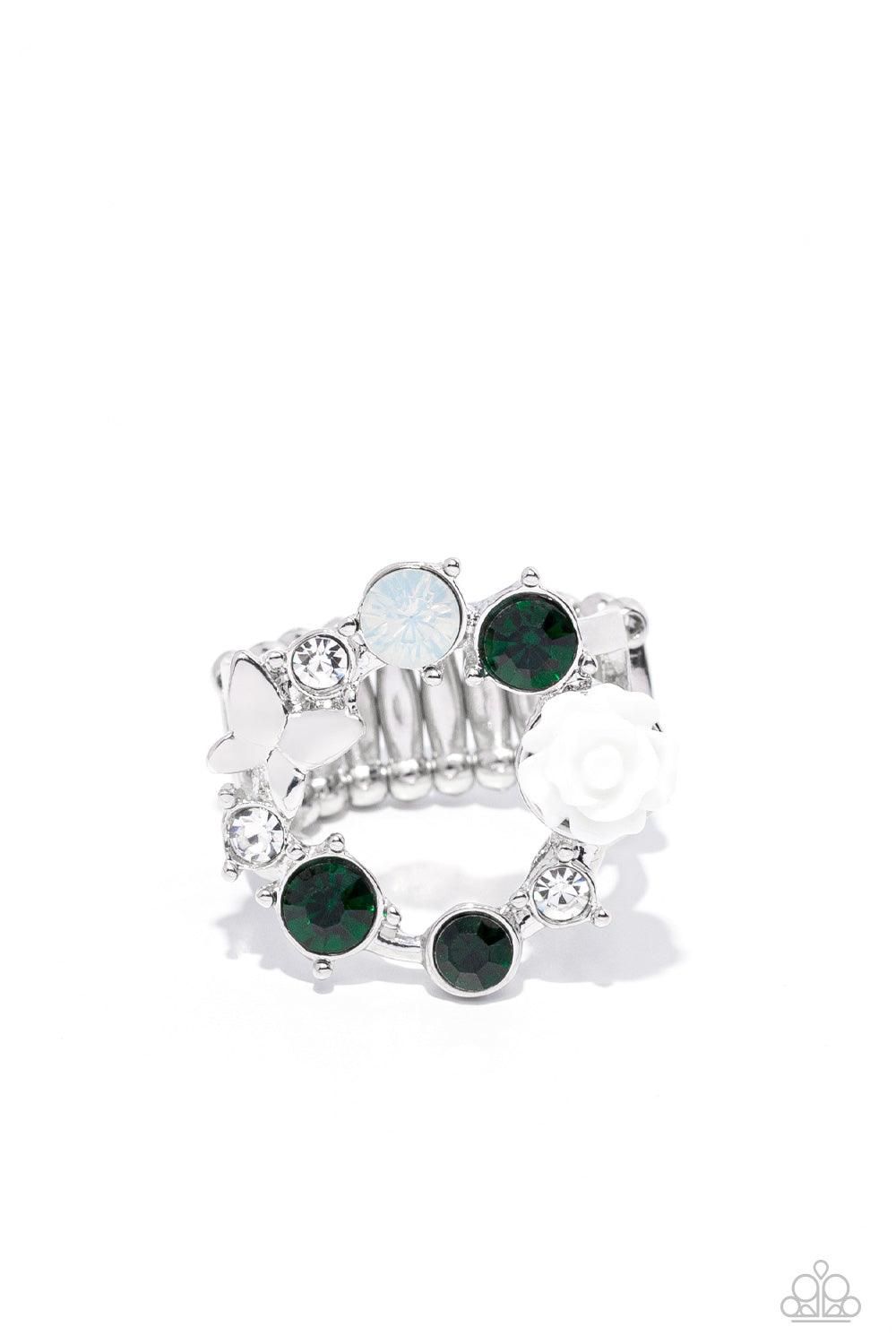 Paparazzi Accessories Butterfly Bustle - Green A glitzy collection of green, opal, and white rhinestones coalesce into a sparkly wreath atop the finger. Elegantly enhanced with a white resin rosebud, a dainty silver butterfly flutters atop the glittery ce