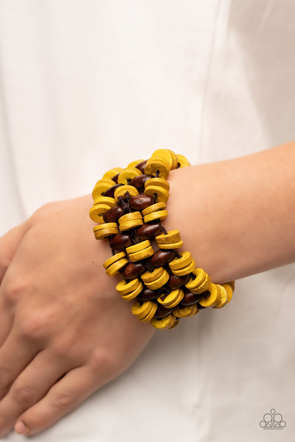 Paparazzi Accessories Galapagos Go-Getter - Yellow A tropical collection of distressed yellow wooden discs and brown oval wooden beads are decoratively threaded along stretchy bands around the wrist, creating a refreshing pop of summery fun. Sold as one i