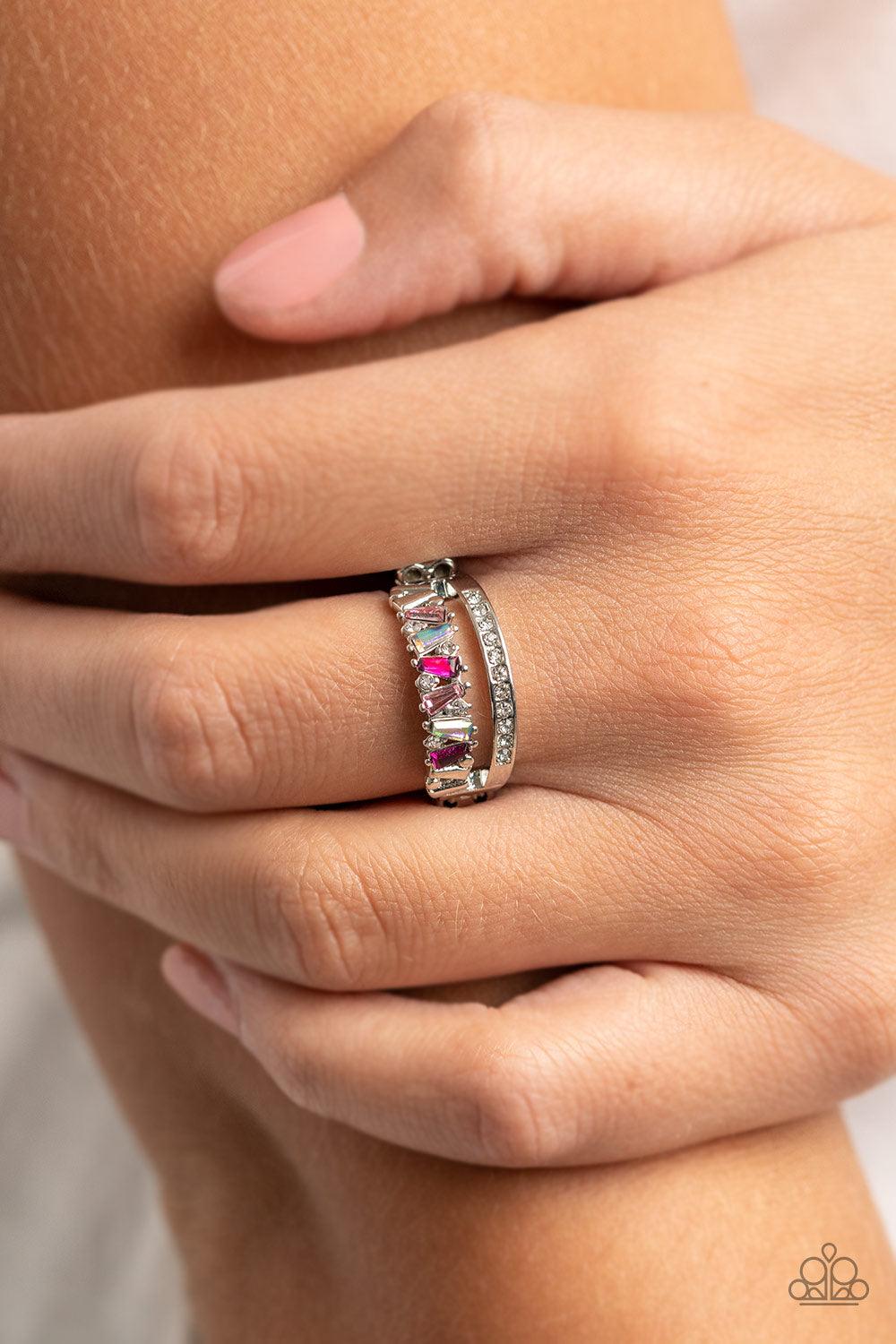 Paparazzi Accessories Fractal Fascination - Pink Infused with a timeless band of white rhinestones, a dainty collection of trapezoidal light pink, dark pink, and iridescent rhinestones staggers across the finger for a glamorously layered look. Features a