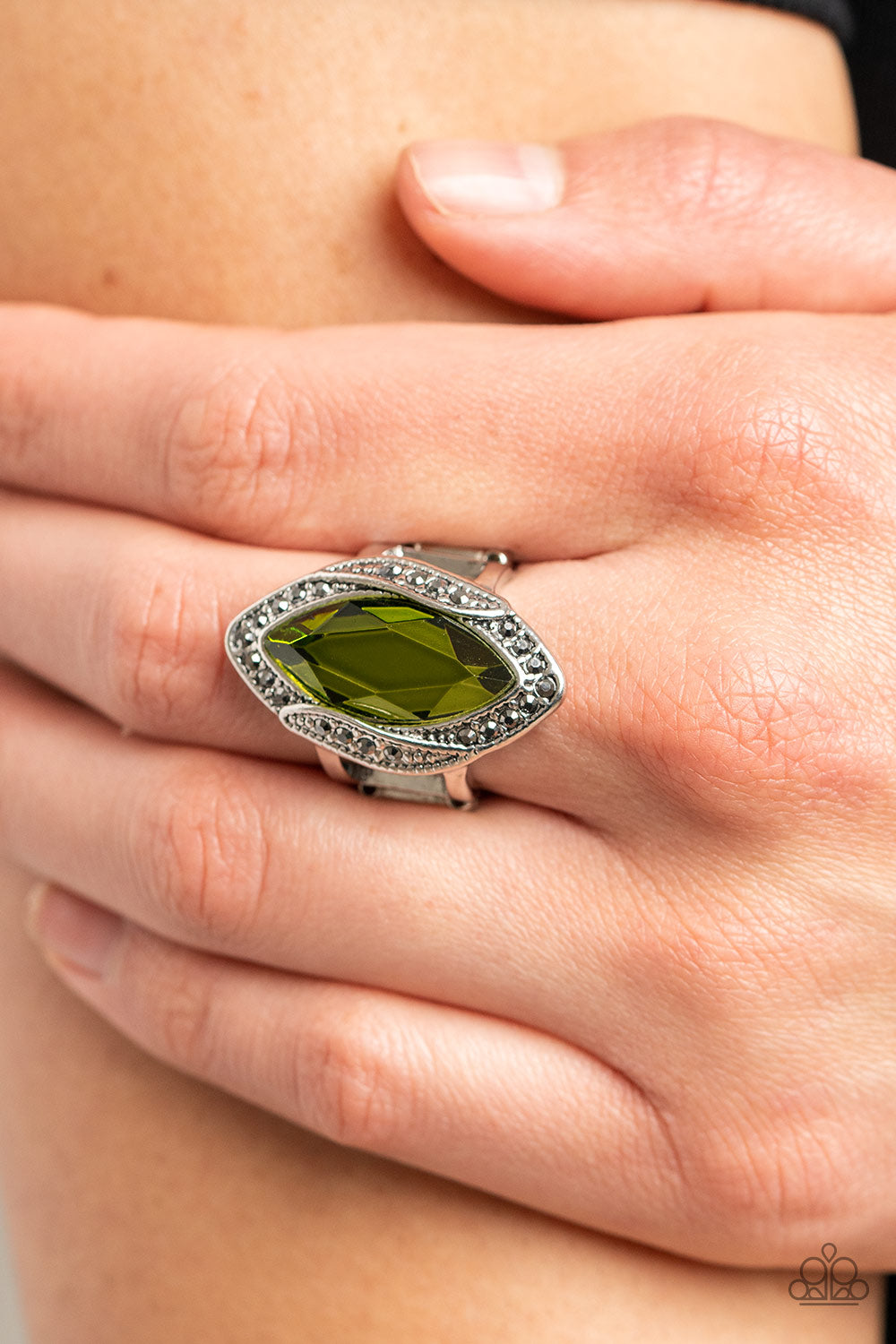 Paparazzi Accessories Let Me Take a REIGN Check - Green Dotted in dainty hematite rhinestones, folds of silver gather around an oversized marquise cut green gem for a gritty display of glitter atop the finger. Features a stretchy band for a flexible fit.