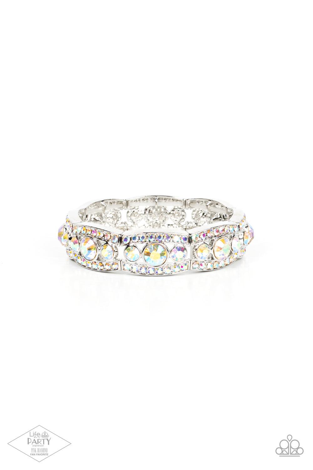 Paparazzi Accessories Easy On The ICE - Multi Iridescent rhinestone encrusted silver bars flank a dazzling trio of oversized iridescent rhinestones, coalescing into a glittery frame. The sparkly frames are threaded along stretchy bands around the wrist, c