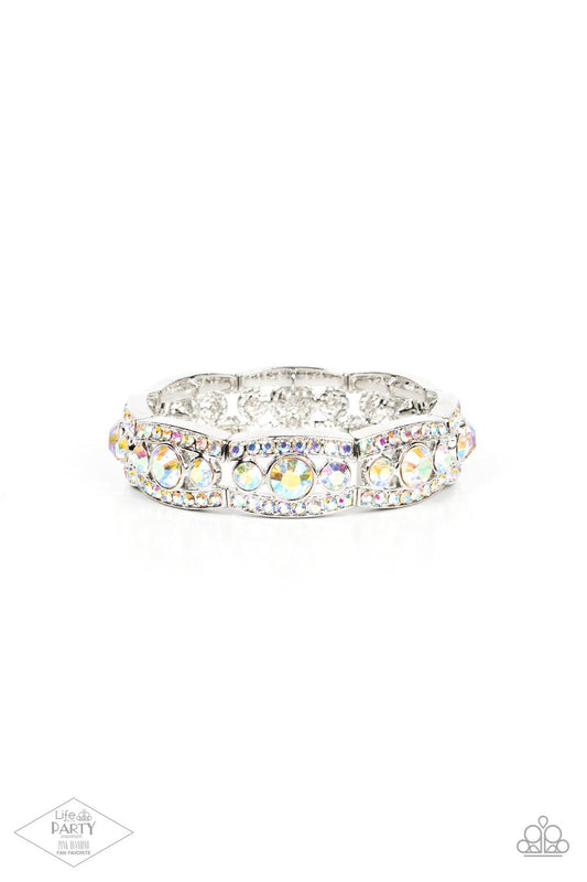 Paparazzi Accessories Easy On The ICE - Multi Iridescent rhinestone encrusted silver bars flank a dazzling trio of oversized iridescent rhinestones, coalescing into a glittery frame. The sparkly frames are threaded along stretchy bands around the wrist, c