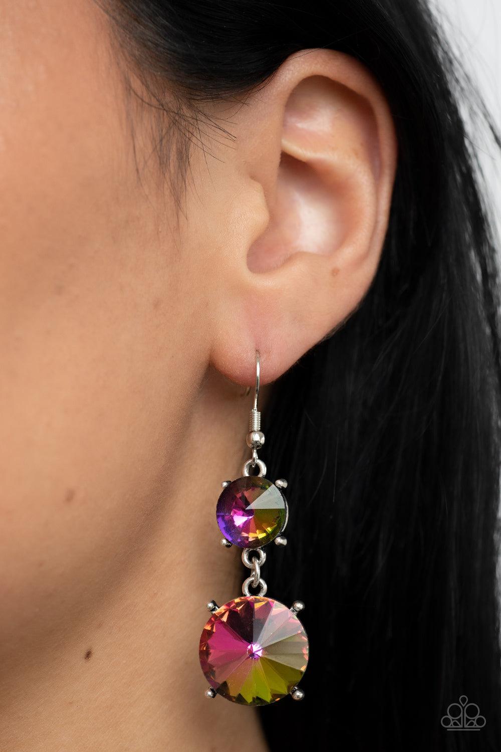 Paparazzi Accessories Sizzling Showcase - Multi Featuring pronged silver fittings, two oversized oil spill rhinestones dramatically link into a bold smoldering lure as they drip dazzlingly from the ear. Earring attaches to a standard fishhook fitting. Sol