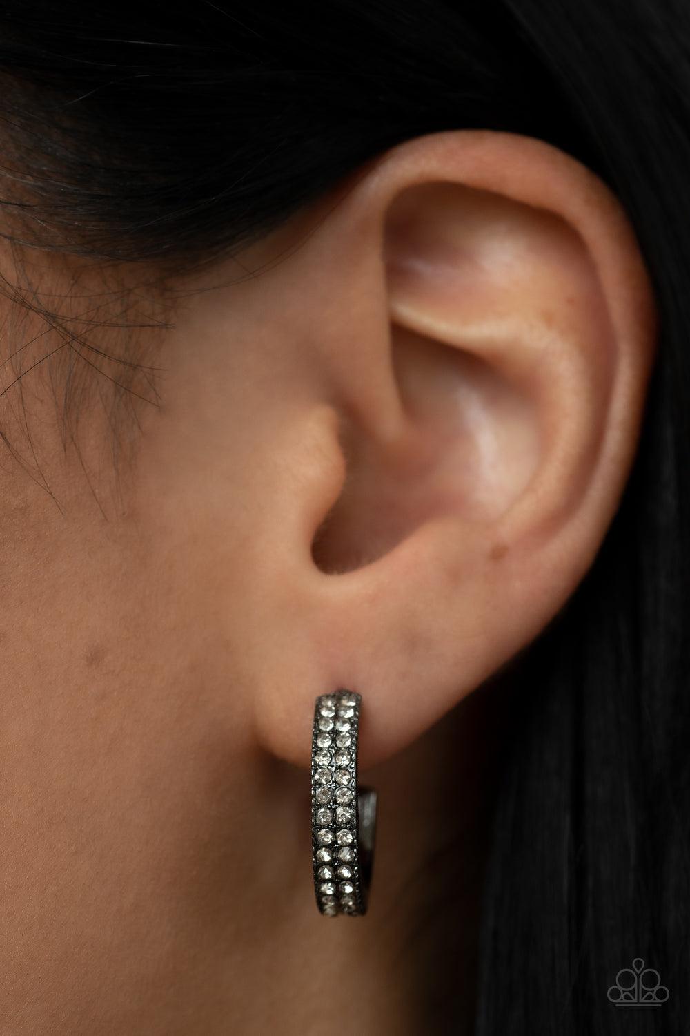 Paparazzi Accessories Small Town Twinkle - Black Two rows of glassy white rhinestones encrust the front of a dainty gunmetal hoop, resulting in a timeless twinkle. Earring attaches to a standard post fitting. Hoop measures approximately 3/4" in diameter.