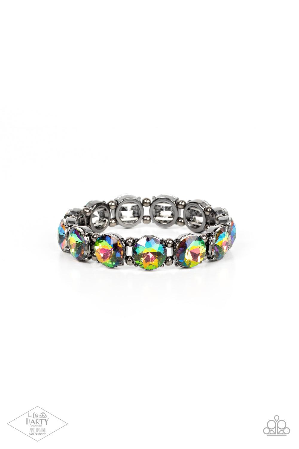 Paparazzi Accessories Glitzy Glamorous - Multi A row of exaggerated oil spill rhinestones is threaded along stretchy bands and wraps boldly around the wrist. Dainty gunmetal beads separate each rhinestone, adding a metallic grit to the piece. Sold as one