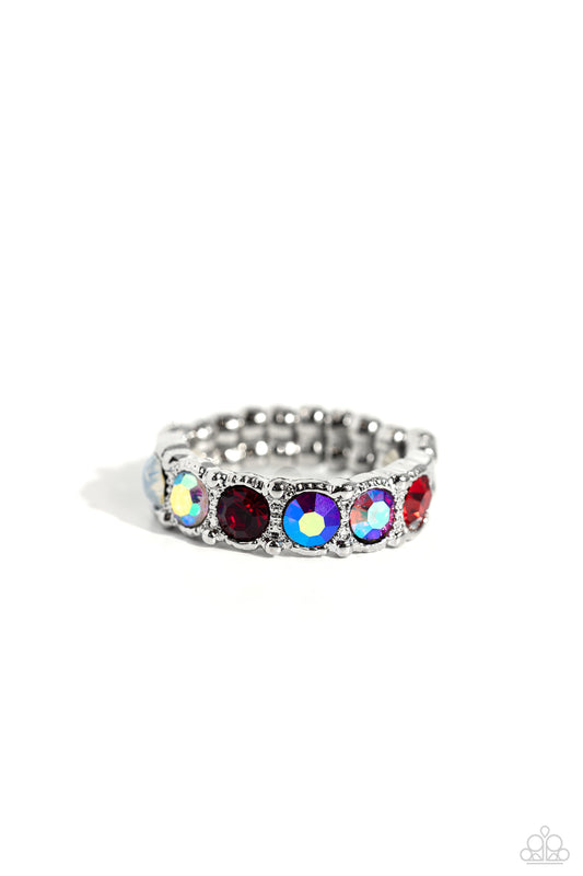 Paparazzi Accessories Taming Twilight - Red A glitzy collection of iridescent, red, and opal rhinestones encrusts the front of a studded silver band, result in a sparkly spectrum of color across the finger. Features a dainty stretchy band for a flexible f