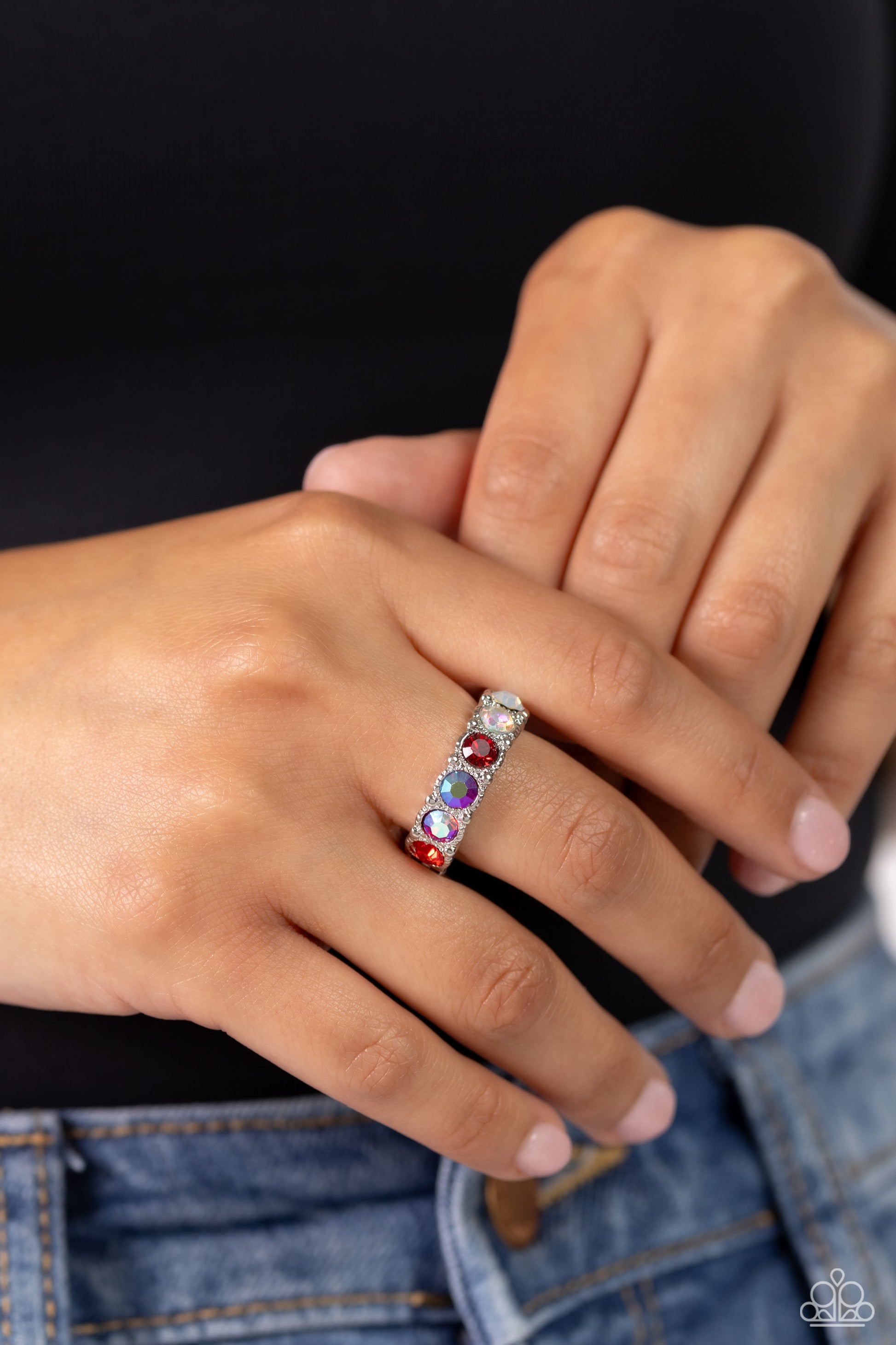 Paparazzi Accessories Taming Twilight - Red A glitzy collection of iridescent, red, and opal rhinestones encrusts the front of a studded silver band, result in a sparkly spectrum of color across the finger. Features a dainty stretchy band for a flexible f