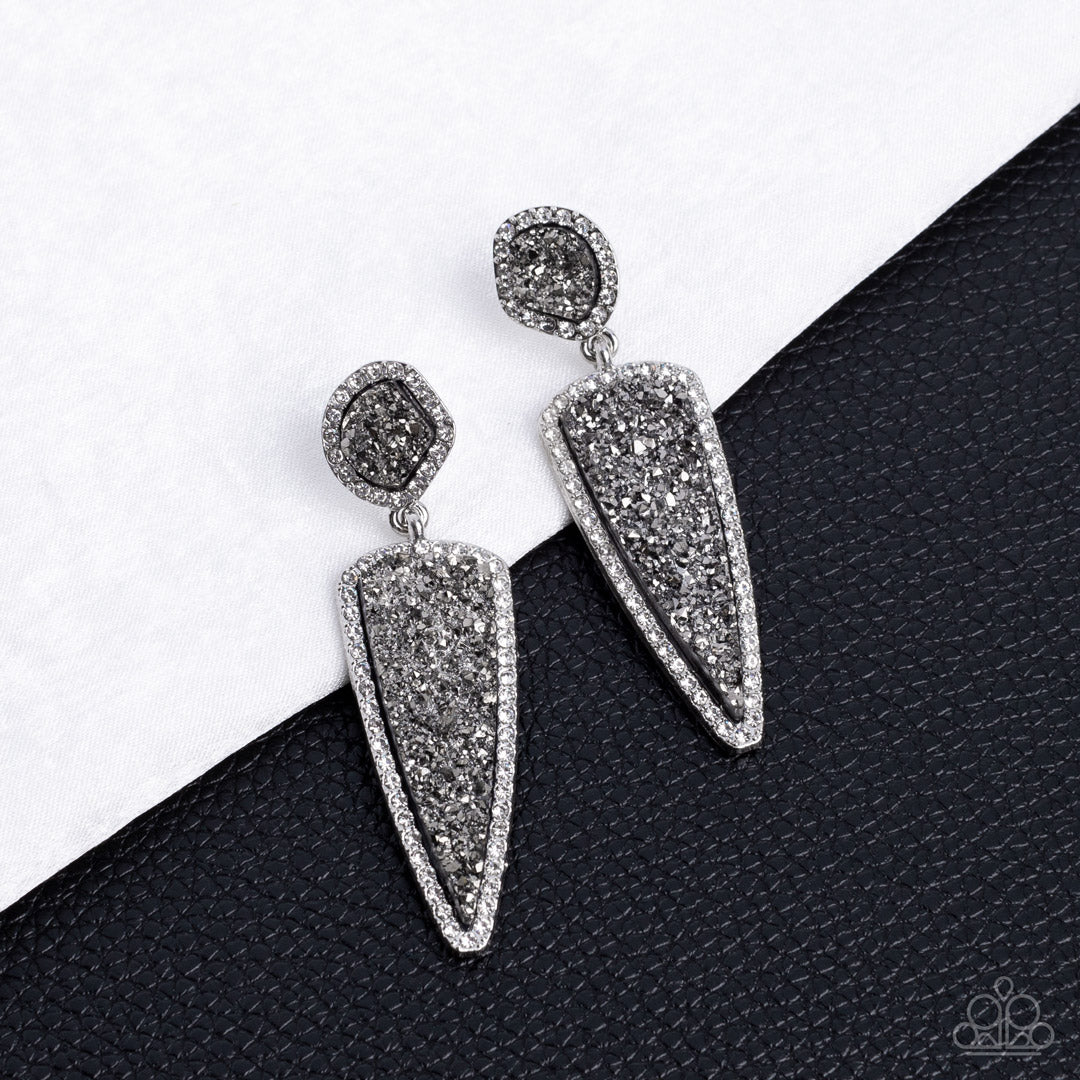 Paparazzi Accessories Druzy Desire - Silver Featuring asymmetrical and triangular cuts, a pair of black druzy-like accents are encased inside white rhinestone dotted silver frames as they link into a jaw-dropping lure. Earring attaches to a standard post