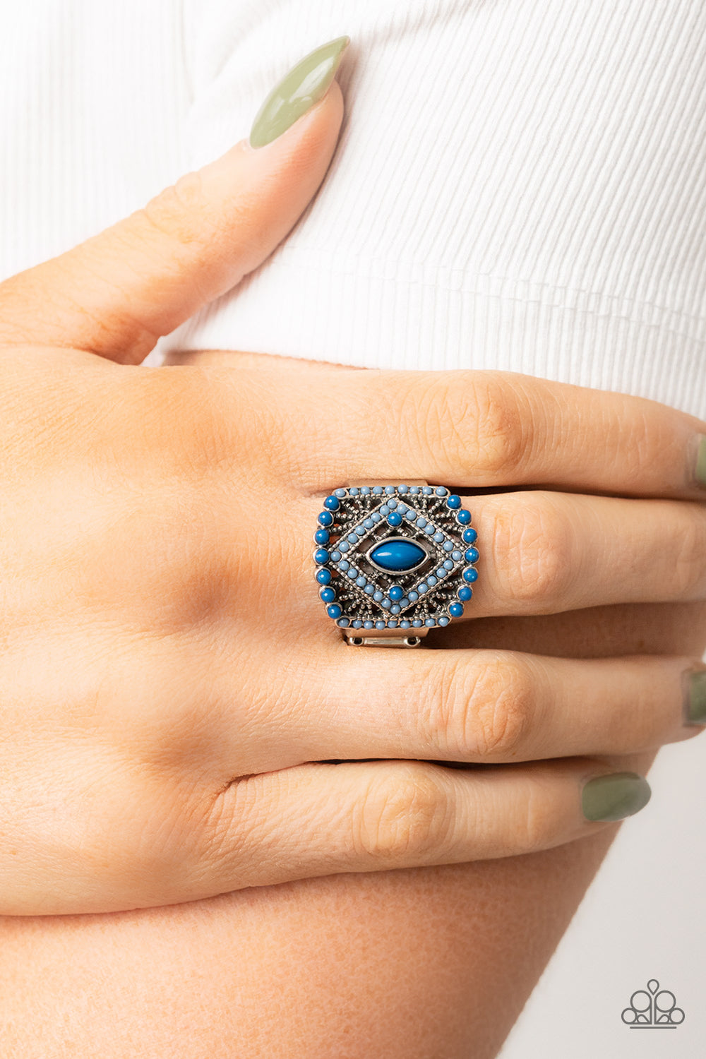 Paparazzi Accessories Amplified Aztec - Blue Dainty Spring Lake and Mykonos Blue beads adorn the front of an airy silver frame radiating with studded geometric texture, culminating into a colorful textile inspired pattern atop the finger. Features a stret
