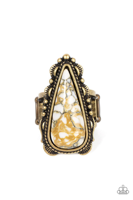 Paparazzi Accessories Canyon Collector - Brass Infused with brassy shimmer, an oversized white teardrop stone is nestled inside a brass frame studded and embellished in antiqued brass details for an authentic finish. Features a stretchy band for a flexibl