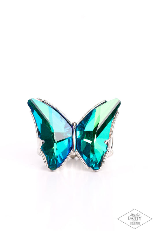 Paparazzi Accessories Fluorescent Flutter - Green Featuring a stellar blue UV finish, a pair of glittery green gems adorns the wings of a silver butterfly atop the finger for an eye-catching finish. Features a stretchy band for a flexible fit. Due to its