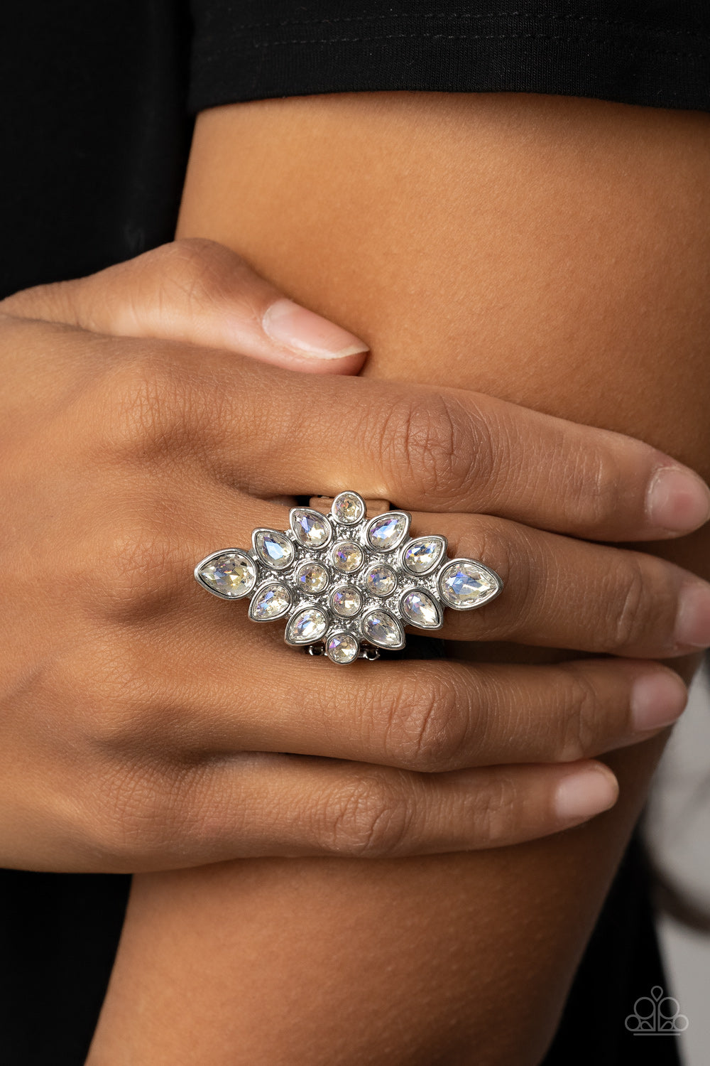 Paparazzi Accessories Combustible Iridescence - White Round and teardrop iridescent rhinestones fan out across a diamond shaped silver frame, resulting in a stellar centerpiece atop the finger. Features a stretchy band for a flexible fit. Sold as one indi