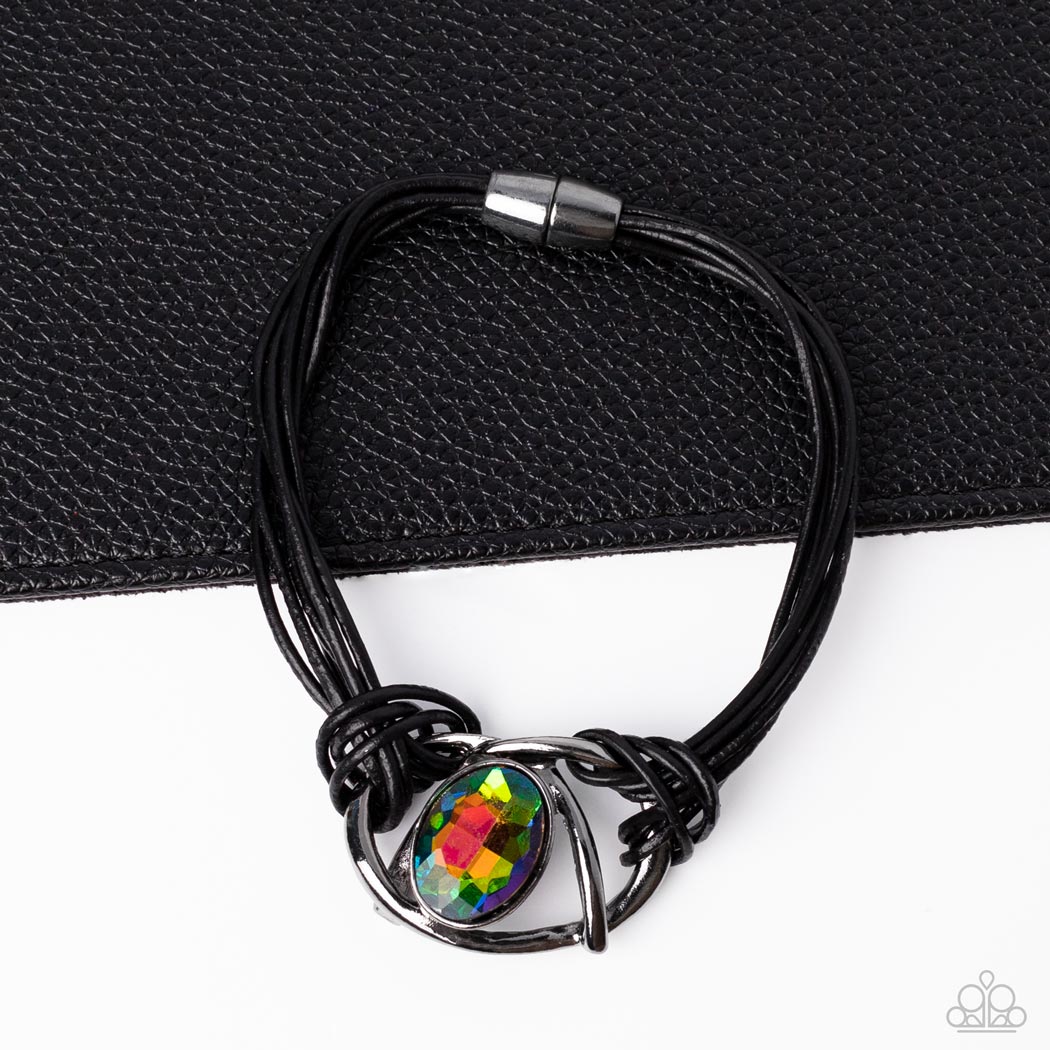 Paparazzi Accessories Keep Your Distance - Multi Shiny gunmetal bars abstractly twist around an oversized oval oil spill gem, resulting in a mesmerizing centerpiece that is knotted in place with layers of black leather cording. Features a magnetic closure