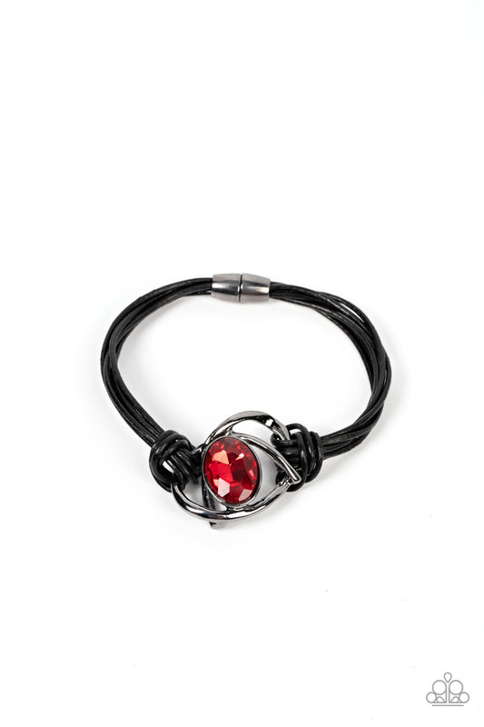 Paparazzi Accessories Keep Your Distance - Red Shiny gunmetal bars abstractly twist around an oversized oval red gem, resulting in a mesmerizing centerpiece that is knotted in place with layers of black leather cording. Features a magnetic closure. Sold a