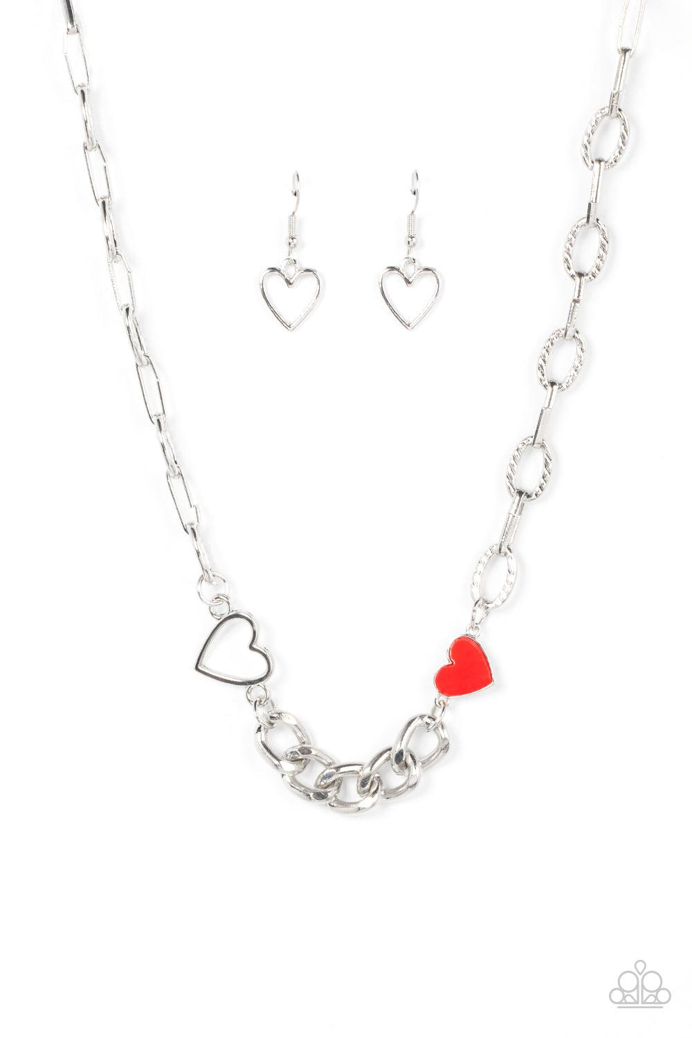 Paparazzi Accessories Little Charmer - Red A pair of shiny silver and red hearts asymmetrically adorn sections of mismatched silver chain, resulting in a flirtatious pop of color below the collar. Features an adjustable clasp closure. Sold as one individu