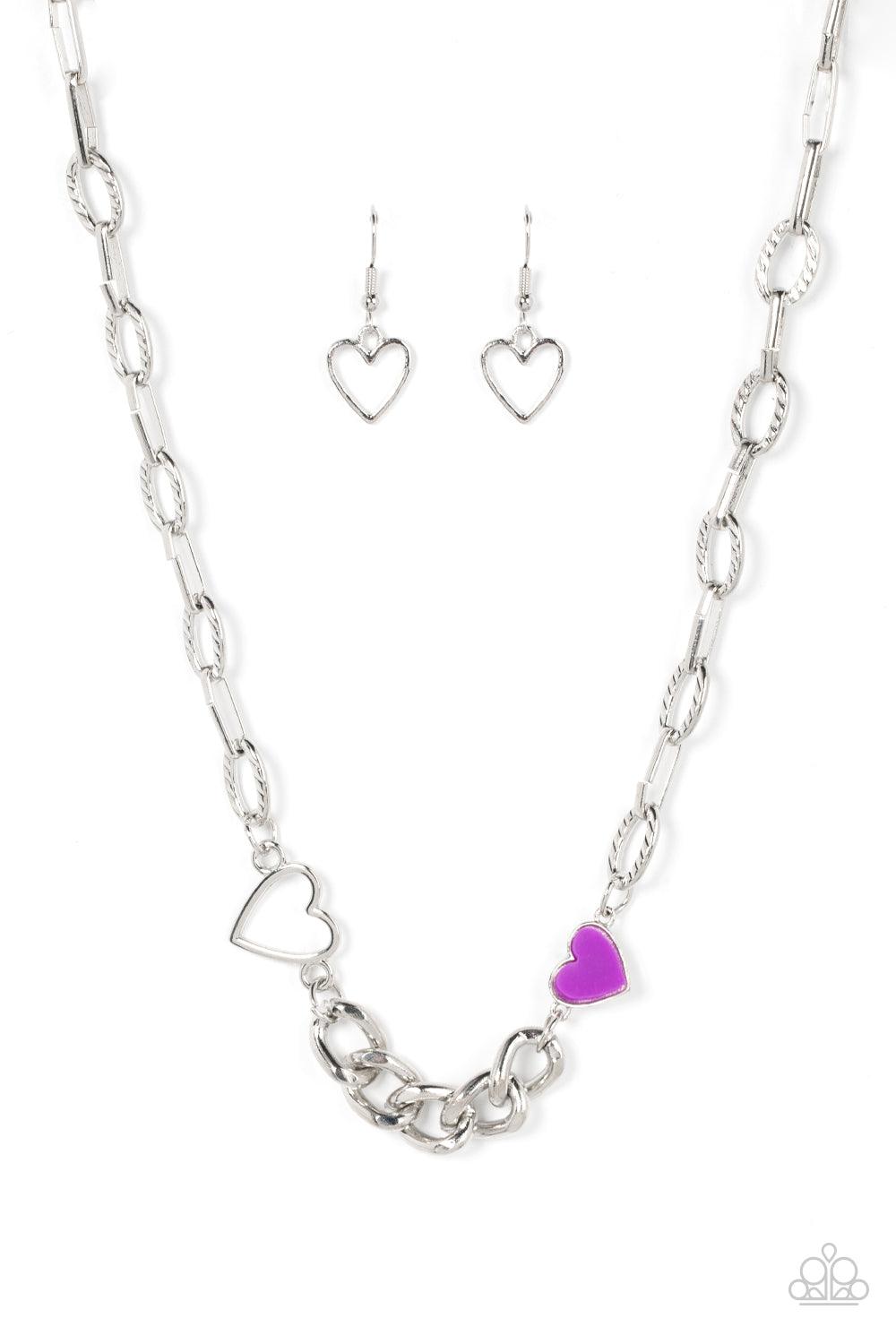 Paparazzi Accessories Little Charmer - Purple A pair of shiny silver and purple hearts asymmetrically adorn sections of mismatched silver chain, resulting in a flirtatious pop of color below the collar. Features an adjustable clasp closure. Sold as one in