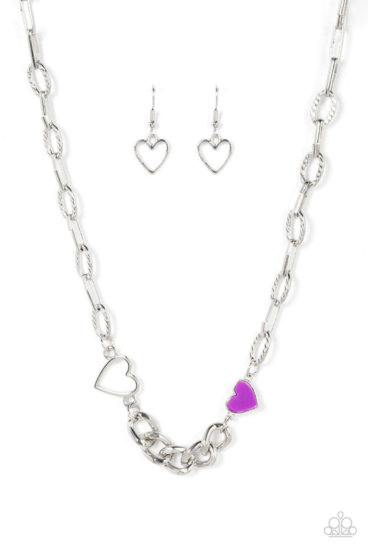 Paparazzi Accessories Little Charmer - Purple A pair of shiny silver and purple hearts asymmetrically adorn sections of mismatched silver chain, resulting in a flirtatious pop of color below the collar. Features an adjustable clasp closure. Sold as one in