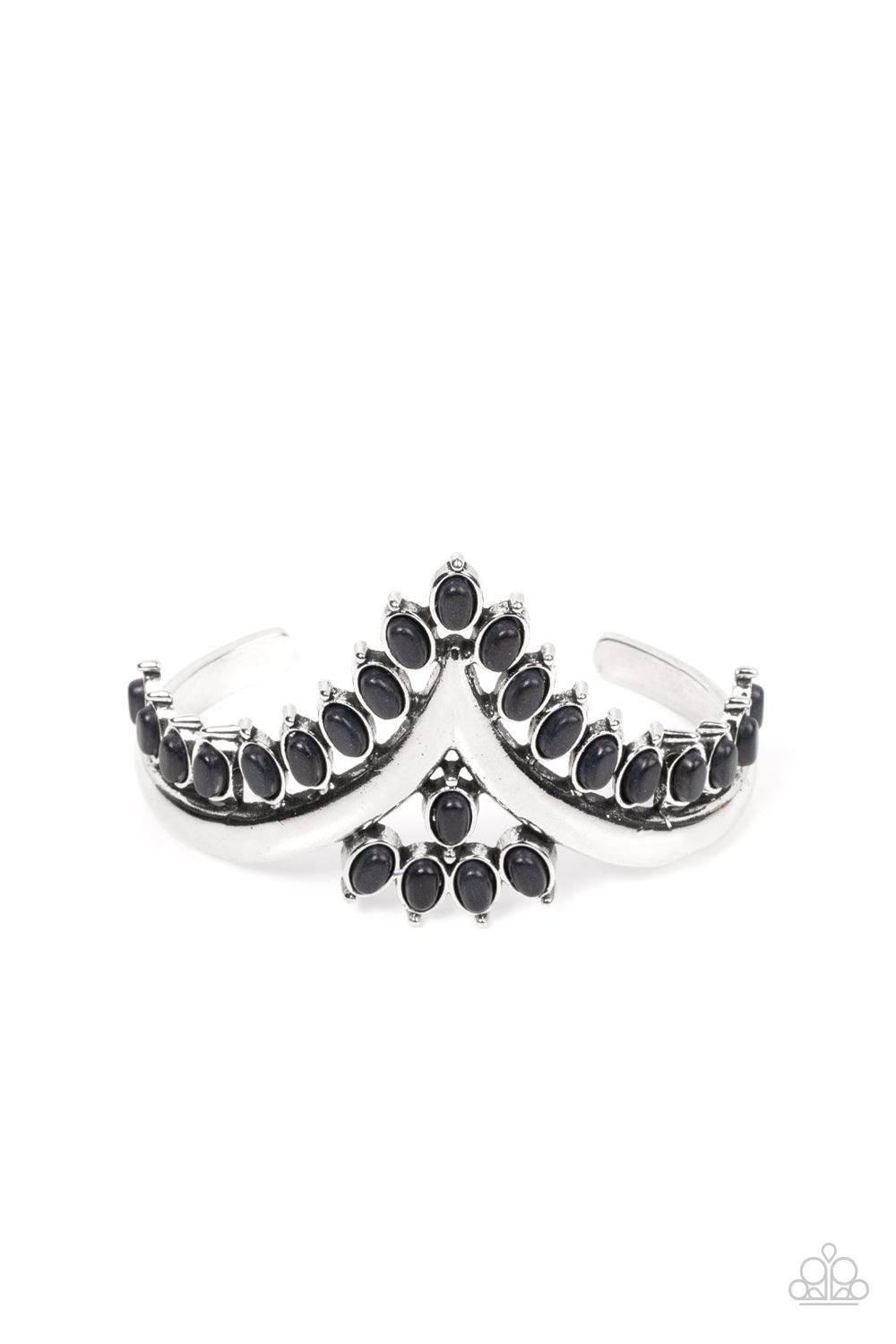 Paparazzi Accessories Teton Tiara - Black Black oval stones, encased in studded silver frames, line the edge of a daring V-shaped silver cuff. A gathering of black stones adorns the center of the bracelet, adding a finishing touch to the rustically regal